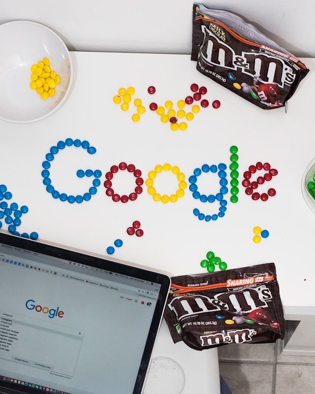 Google search branding created with colorful pieces beside a laptop